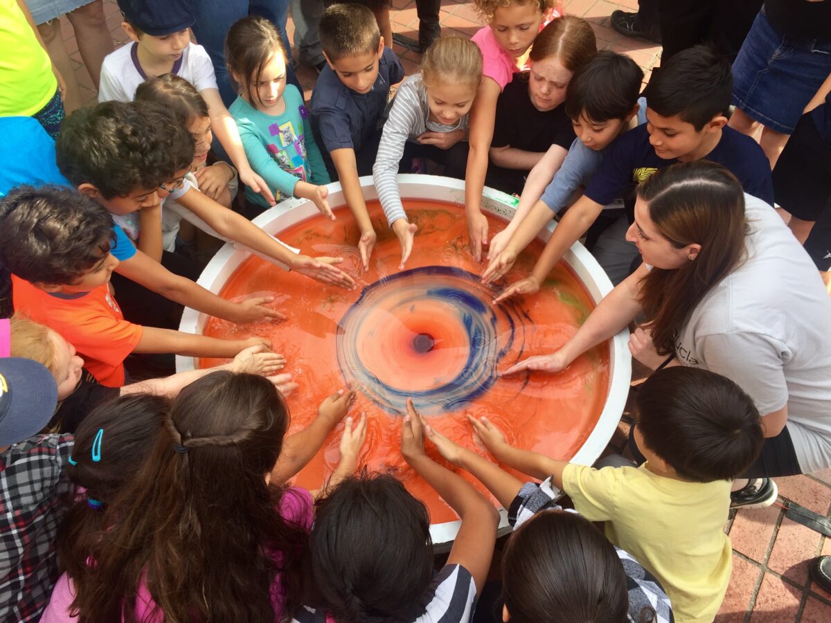 Children participating in a science experiment at Exploring Your Universe 2016
