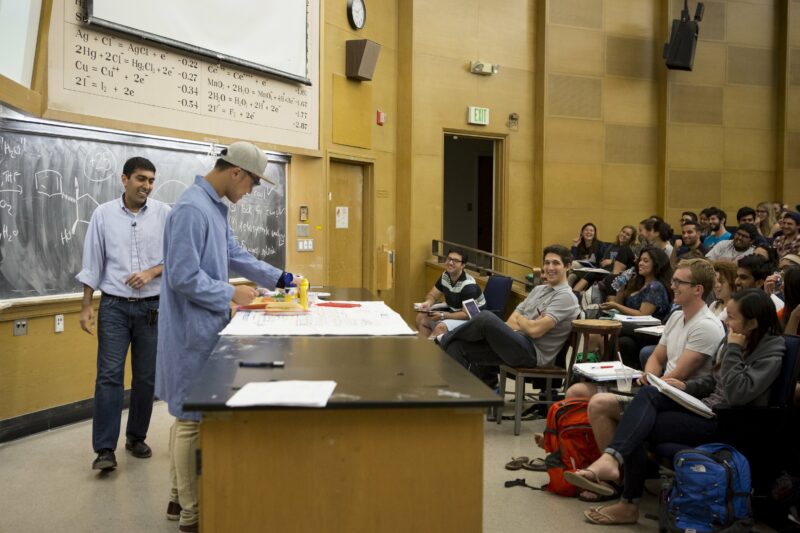 Chemistry professor Niel Garg at the front of his class, as a student demonstrates a project