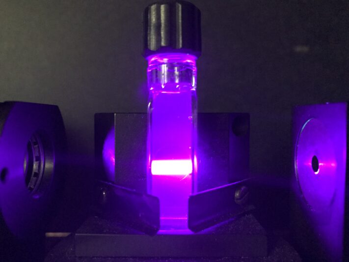 An image of a laser beam aimed at a sample of sub-micron sized crystals suspended in water
