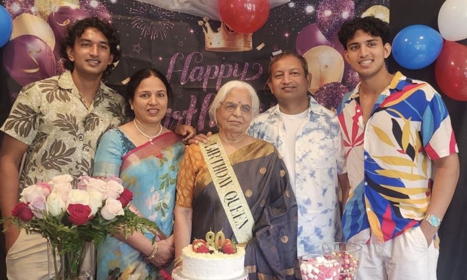 Anish posing for a photo with his family celebrating his grandmother’s birthday
