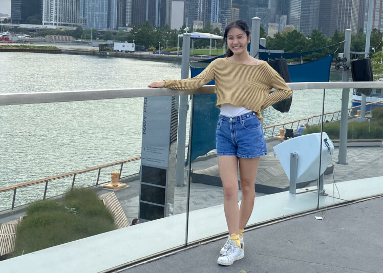 A photo of Elise Tran posing in front of a city skyline