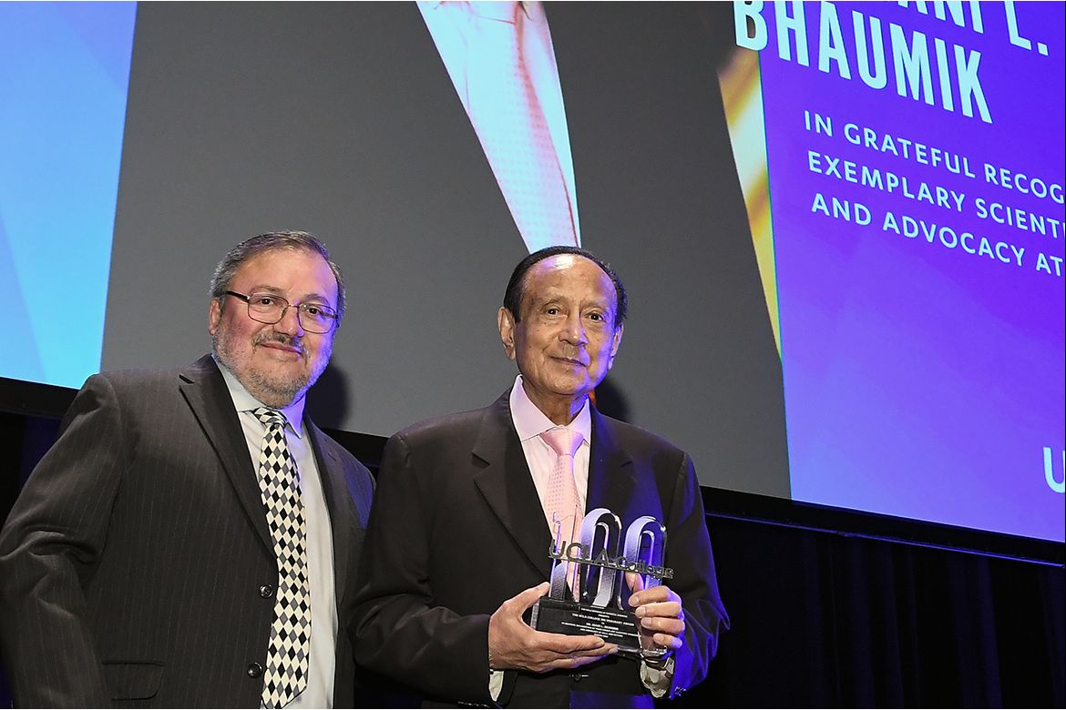 Dean of Physical Sciences Miguel Garcia-Garibay presents Mani Bhaumik with an award honoring his commitment to UCLA
