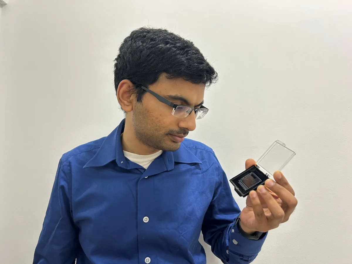 Pradip Gatkine holds a photonic chip in left hand