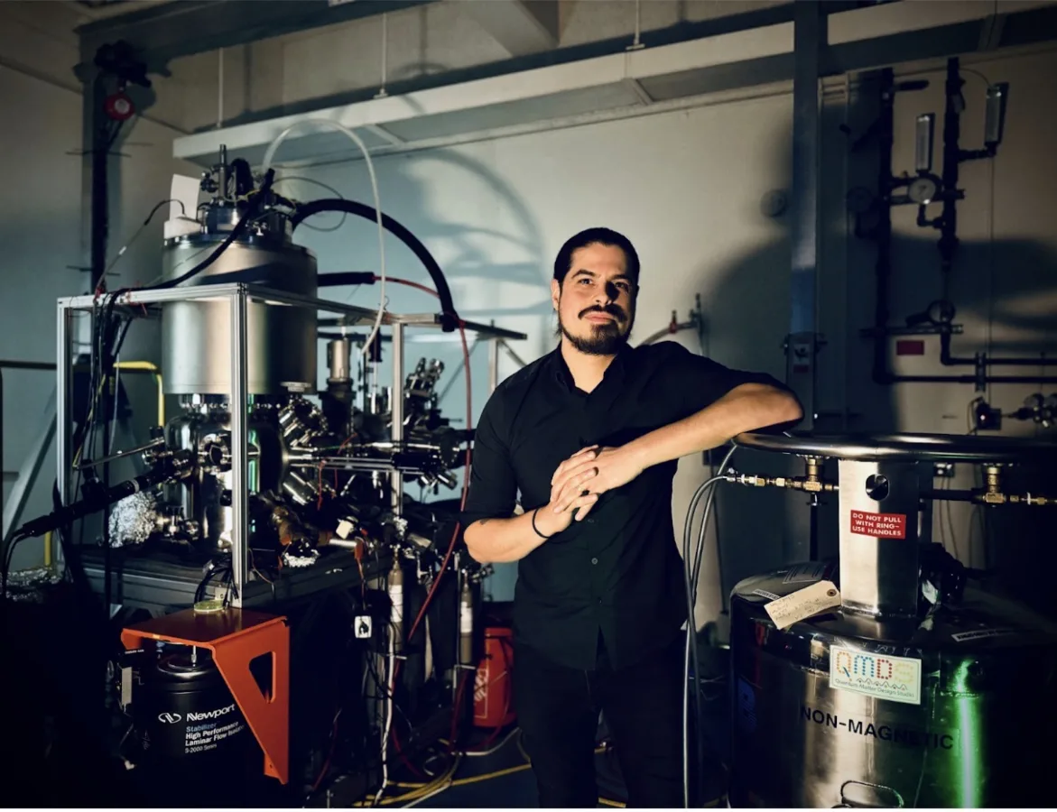 Professor Christopher Gutiérrez poses in his lab with high-tech equipment